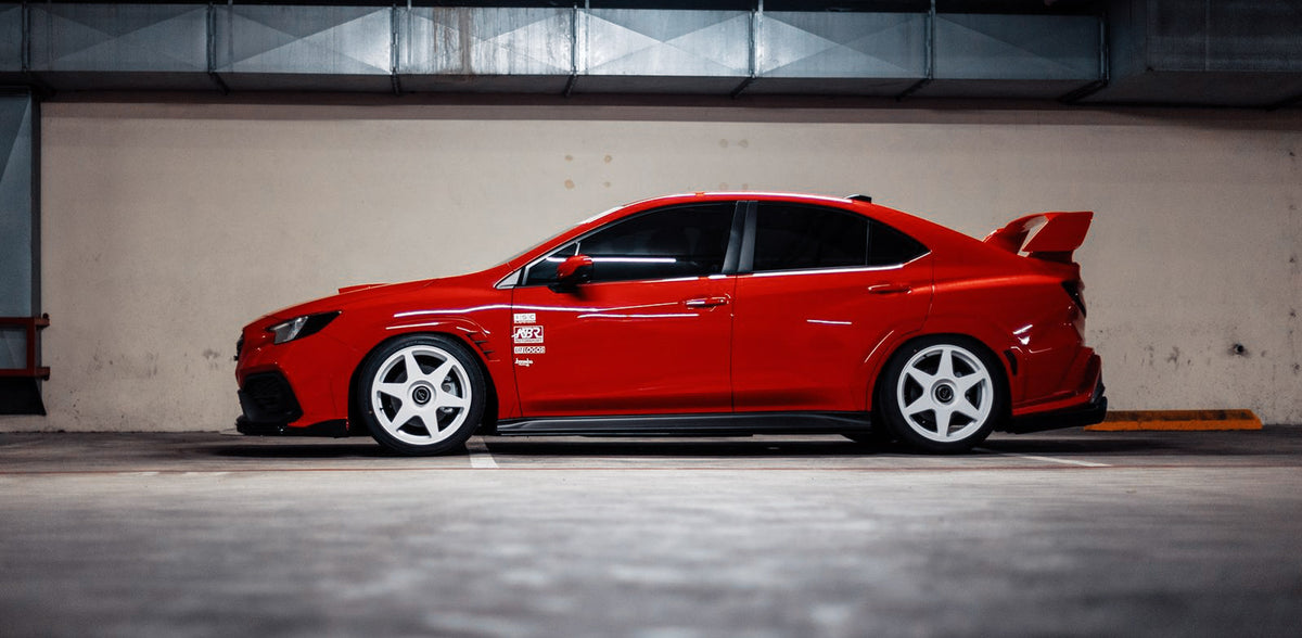 Red 2022 Subaru WRX fitted with white fifteen52 Tarmac EVO wheels