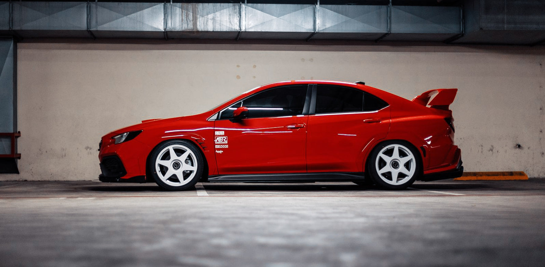 Red Subaru WRX fitted with white fifteen52 Tarmac EVO wheels