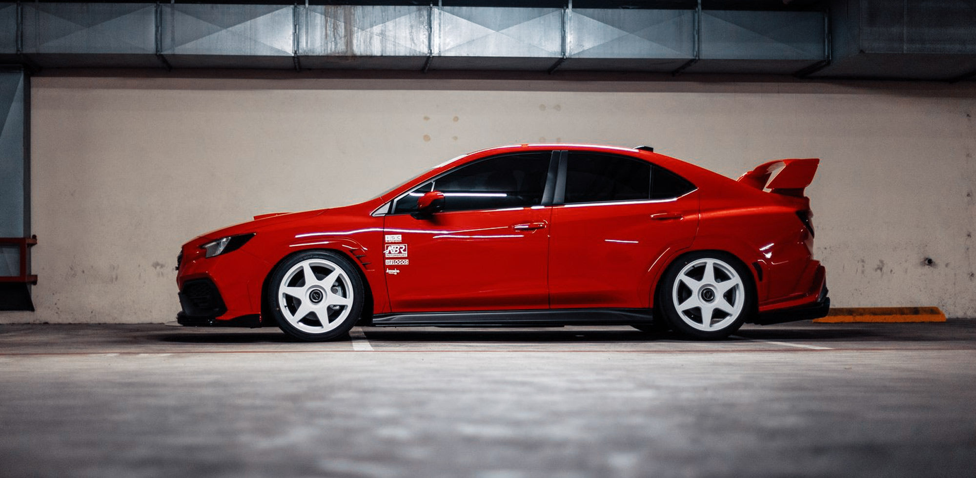 Red 2022 Subaru WRX fitted with white fifteen52 Tarmac EVO wheels